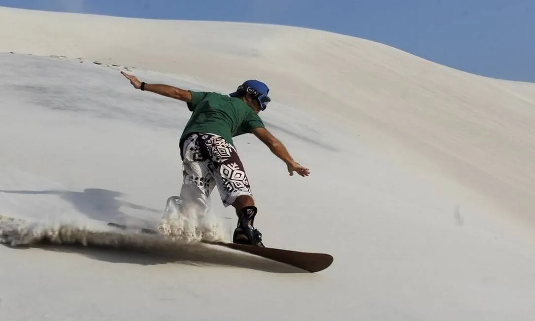 Manobra de sandboard levantando areia